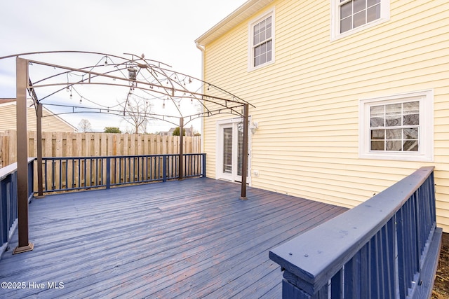 wooden terrace with a gazebo and fence