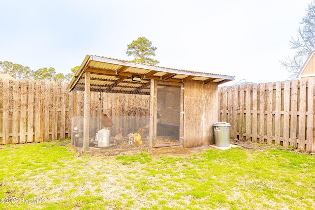 view of poultry coop with a yard and fence