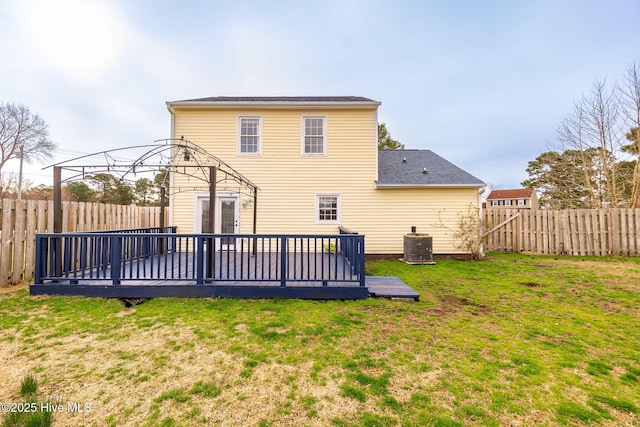 rear view of property featuring a yard, a deck, central AC, and a fenced backyard