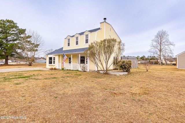 view of front facade featuring a front lawn and covered porch