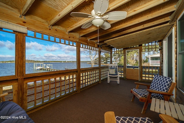 sunroom / solarium with a water view and ceiling fan