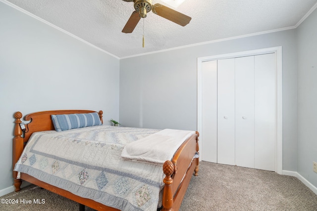 carpeted bedroom featuring crown molding, a textured ceiling, a ceiling fan, and a closet