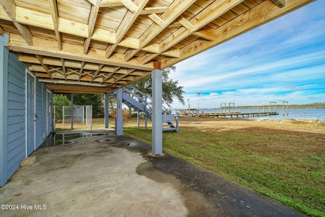 view of patio / terrace featuring a water view and stairs