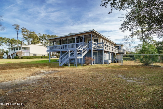 view of front of property featuring a front yard, fence, and stairway