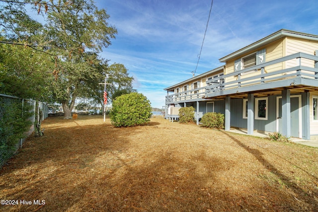 view of yard featuring fence and a wooden deck