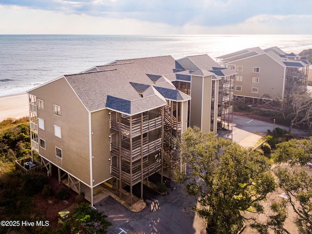 birds eye view of property featuring a water view and a view of the beach