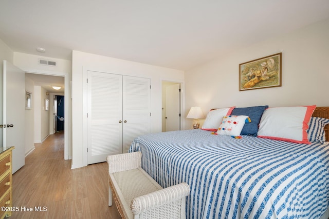 bedroom featuring a closet and light hardwood / wood-style flooring