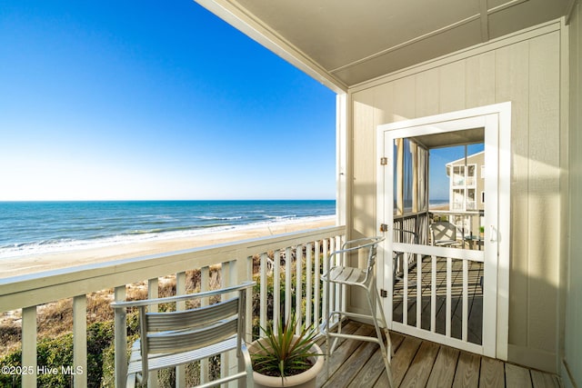 balcony with a view of the beach and a water view