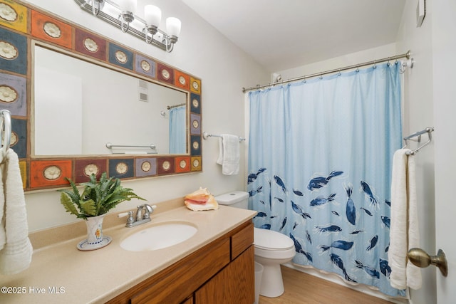 bathroom with vanity, wood-type flooring, curtained shower, and toilet