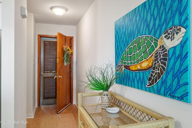 corridor with hardwood / wood-style floors