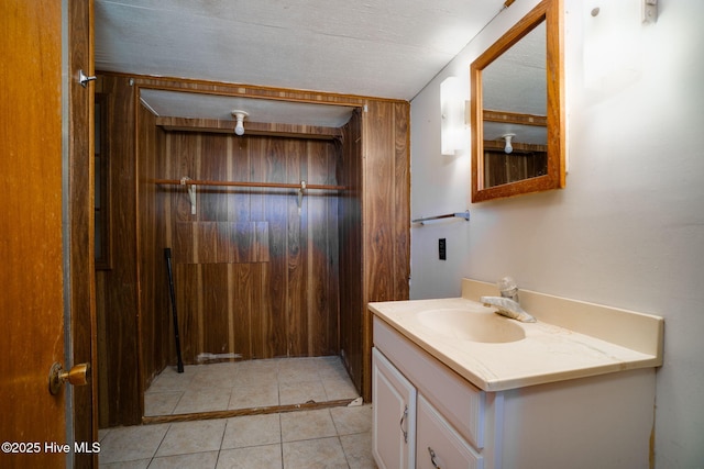 bathroom featuring a textured ceiling, vanity, and tile patterned flooring