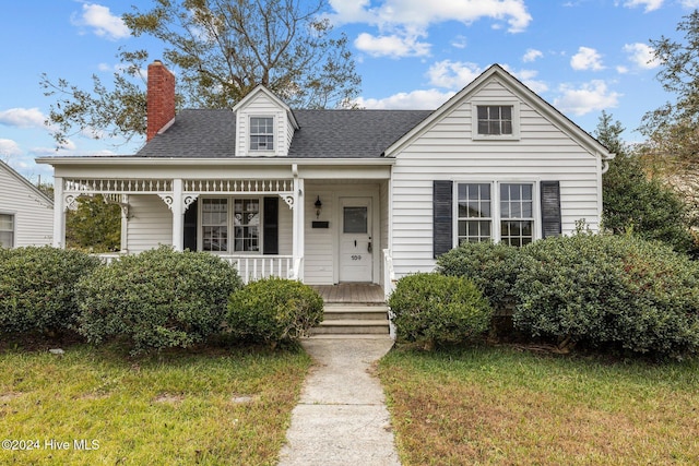 view of front of house with a porch and a front lawn