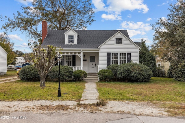 cape cod-style house featuring a porch and a front yard