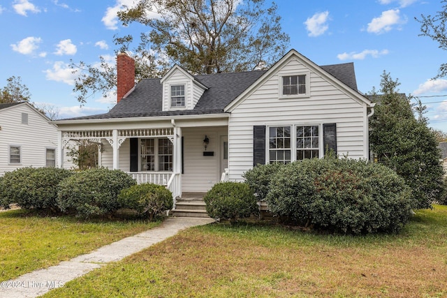 view of front of home with covered porch and a front yard