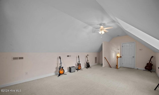 additional living space with ceiling fan, lofted ceiling, and light carpet