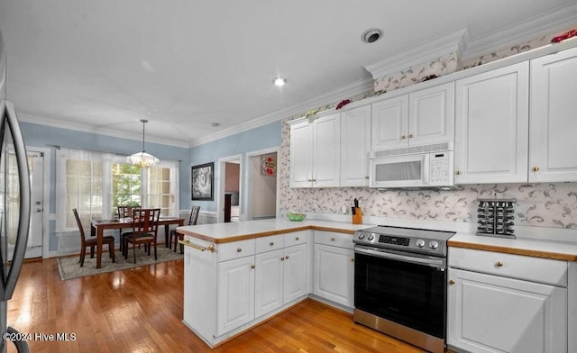 kitchen with white cabinets, kitchen peninsula, stainless steel range with electric stovetop, and hanging light fixtures