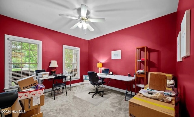 carpeted office featuring ceiling fan