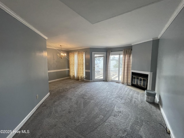 unfurnished living room with a notable chandelier, carpet floors, and ornamental molding