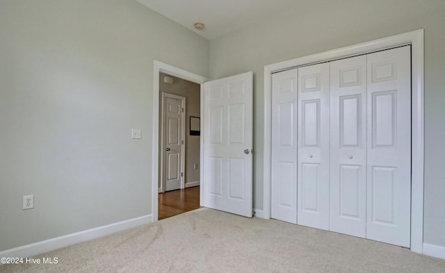 unfurnished bedroom with a closet and carpet