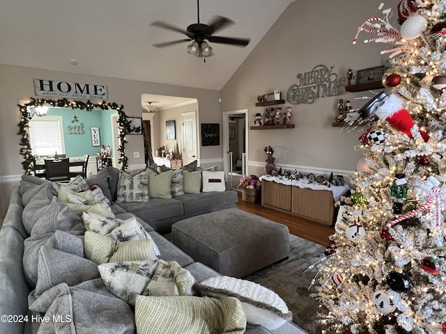 living room featuring hardwood / wood-style flooring, vaulted ceiling, and ceiling fan