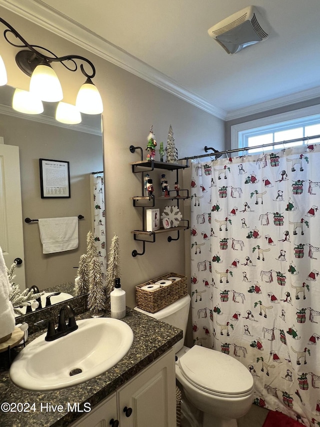 bathroom with vanity, toilet, and crown molding