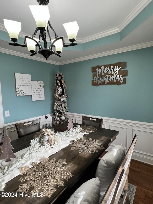 dining space with a chandelier, dark wood-type flooring, and ornamental molding