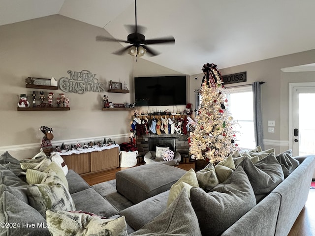 living room with hardwood / wood-style floors, vaulted ceiling, and ceiling fan