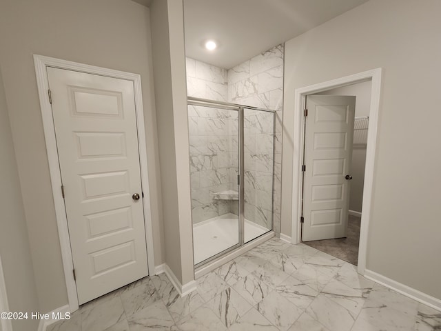 bathroom featuring a shower with door