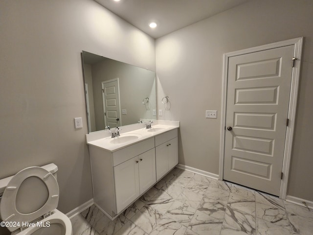 bathroom featuring vanity and toilet