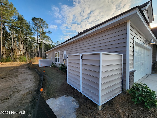 view of side of home featuring a garage