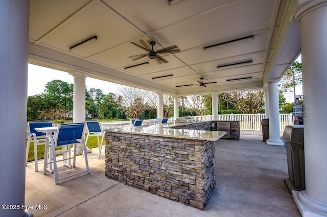 view of patio with a bar and ceiling fan