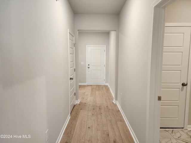 hall with light hardwood / wood-style floors