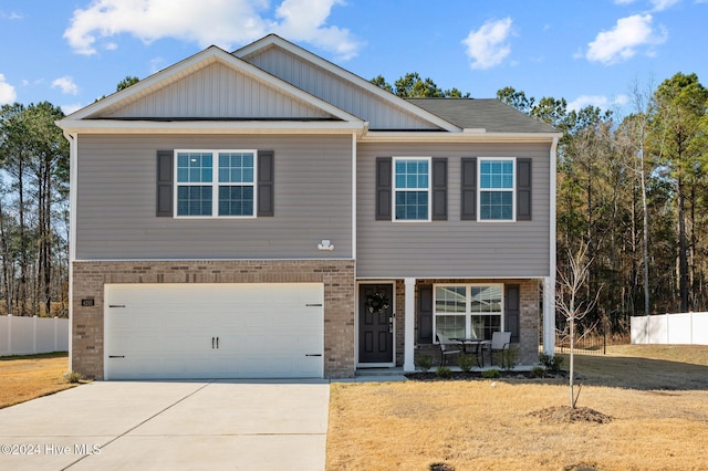 view of front of property featuring a garage and a front lawn