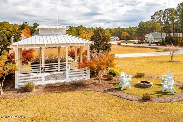 view of yard featuring a gazebo and a fire pit