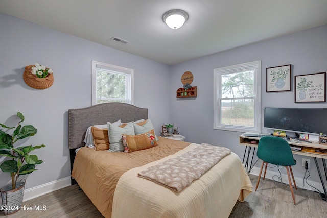 bedroom with hardwood / wood-style floors