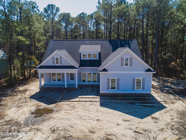 view of front of property featuring board and batten siding and roof with shingles