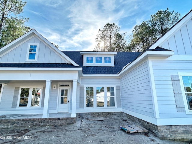 back of property with covered porch