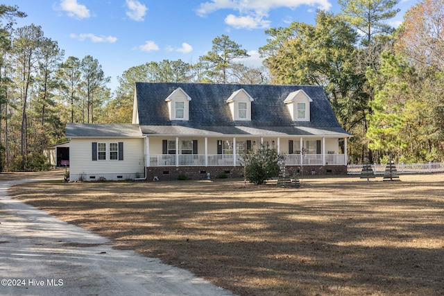 new england style home featuring covered porch