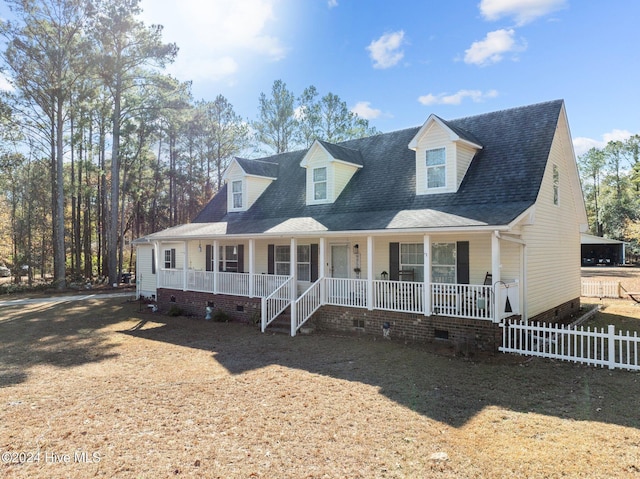 new england style home with a porch