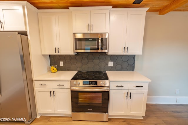 kitchen with white cabinets, light hardwood / wood-style floors, tasteful backsplash, wood ceiling, and appliances with stainless steel finishes