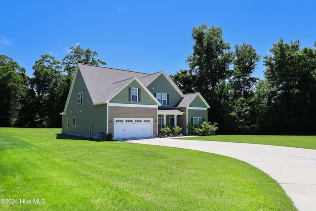 view of front of property featuring a front lawn and a garage