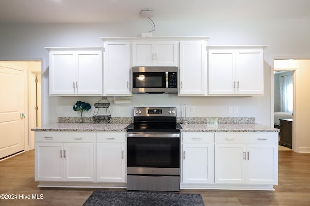 kitchen featuring white cabinetry, light hardwood / wood-style flooring, and stainless steel appliances