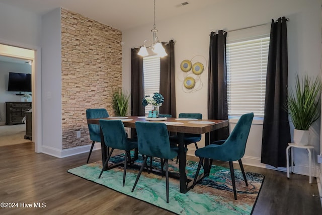 dining room with plenty of natural light, a chandelier, and dark hardwood / wood-style floors