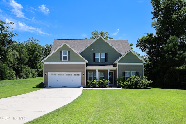 craftsman inspired home with a garage and a front lawn