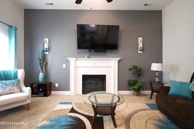 carpeted living room featuring ceiling fan