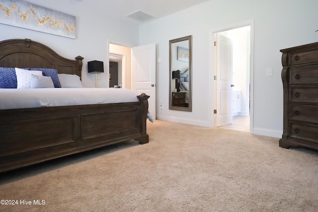 bedroom featuring light colored carpet