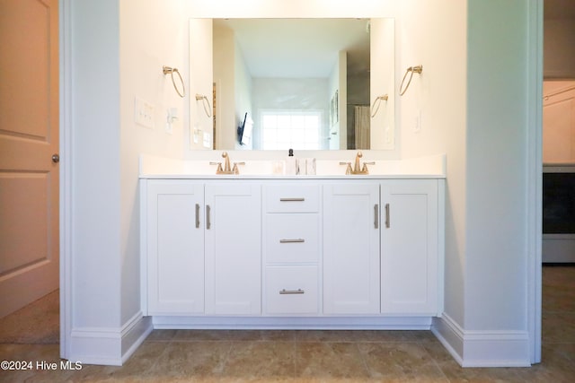 bathroom with tile patterned flooring and vanity