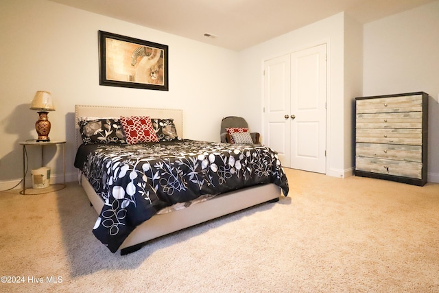 carpeted bedroom featuring a closet