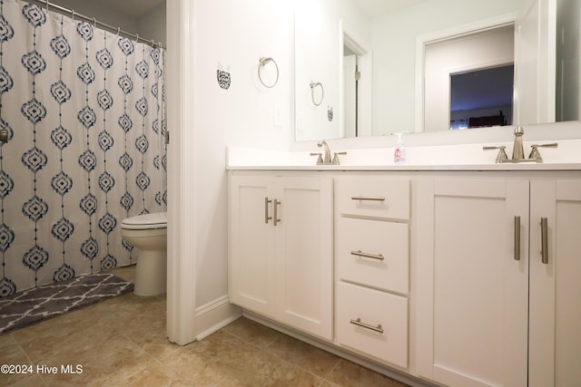 bathroom featuring a shower with shower curtain, tile patterned floors, vanity, and toilet