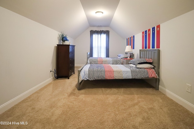 bedroom featuring light carpet and vaulted ceiling